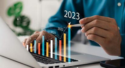 Businessman analyzes profitability of working companies with digital augmented reality graphics, positive indicators in 2023, businessman calculates financial data for long-term investments.